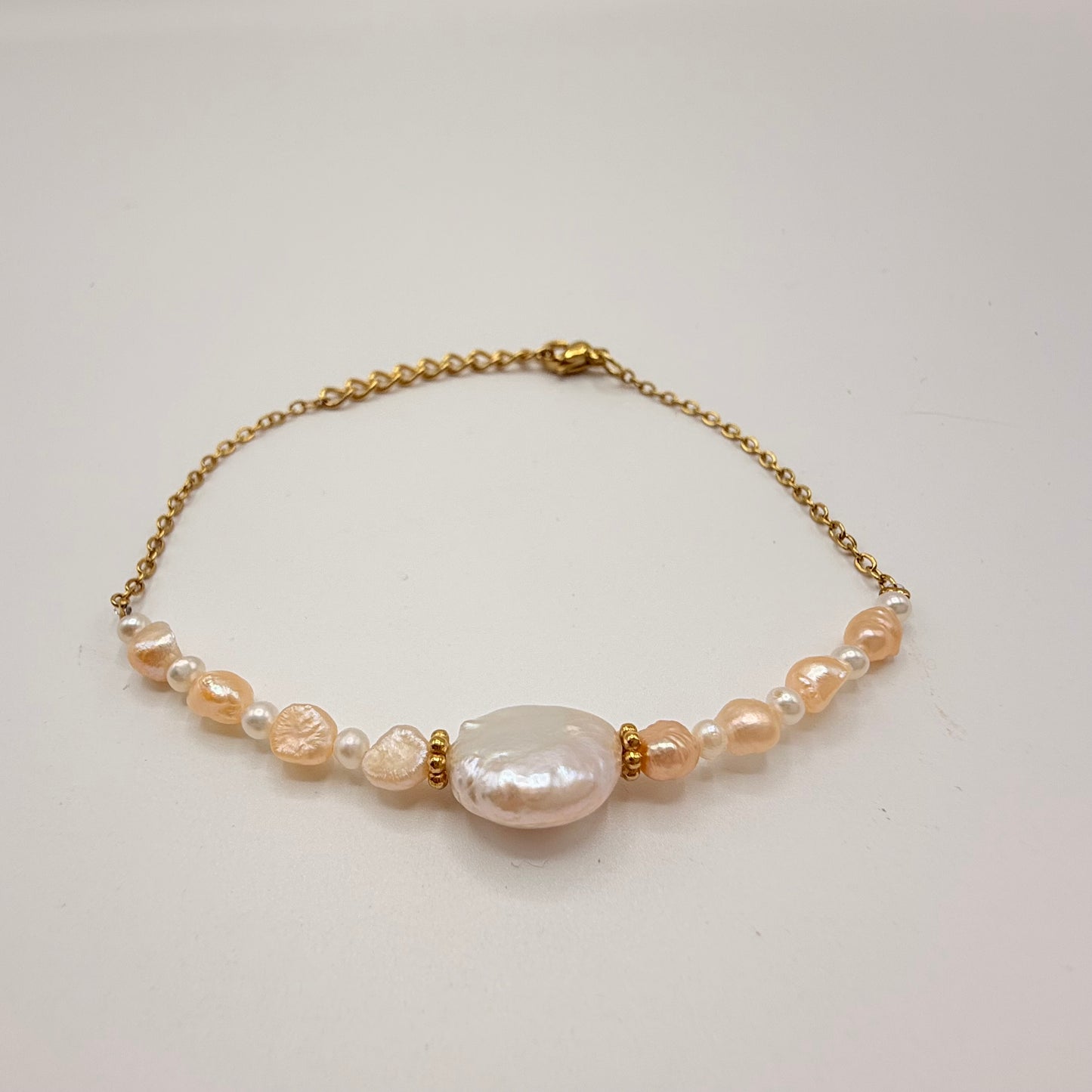 Bracelet perle plate + petite perle irrégulière rose et blanche.